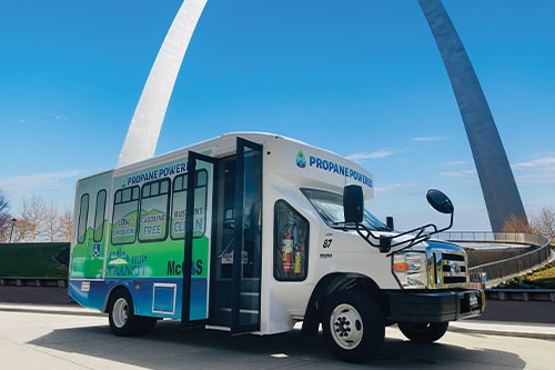 A propane transit bus in front of the St. Louis arch